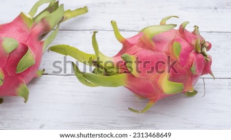 Dragon fruit with white wood grain background.