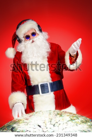 Santa Claus DJ near brilliant sparkling disco ball. Christmas celebration.