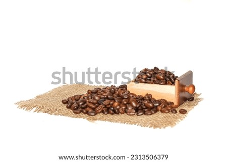 Coffee beans spread around the sack.concept isolated picture style.close up picture with coffee grounds and coffees beans.