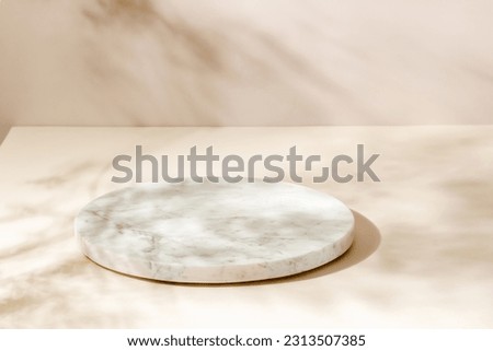 Marble showcase with plant leaves shadows on beige and brown background, minimal background for product presentation	