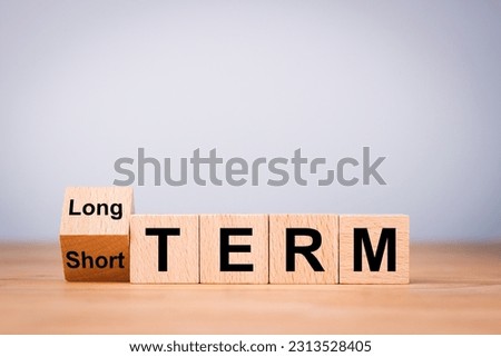 Business investment concept for Flipping od wooden cube block for change short term to long term. Royalty-Free Stock Photo #2313528405