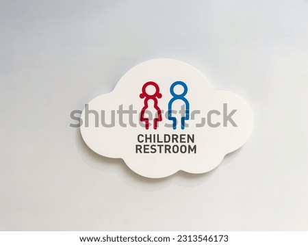 Children restroom sign on white wall. Copy space background