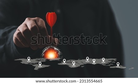 Man hand holding darts with world map. Connecting global travel location technology, Destination points. Map pointer navigation concept, pointing at target of business plan concept, GPS navigator.