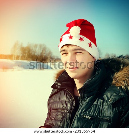 Toned photo Happy Teenager in Santa's Hat outdoor