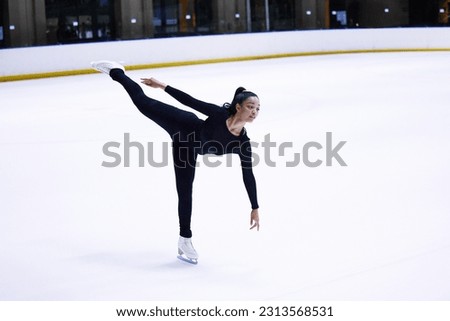 Sport, woman athlete figure skating and at a sports arena on ice floor. Fitness training or exercise, balance or health wellness and female person skate for competition or tournament in sportswear
