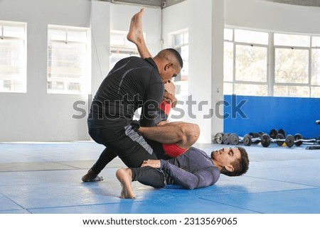 Men sparring, martial arts and fitness in gym with combat, jiu jitsu and students learning self defense skills. Fight, exercise and MMA with fighting sport and male people training at exercise dojo Royalty-Free Stock Photo #2313569065