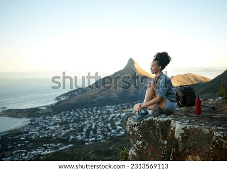 Woman, mountain and sitting with view of cityscape outdoor for exercise in Cape Town. Female hiking, cliff and South Africa for adventure in nature in the morning for wellness on the weekend. Royalty-Free Stock Photo #2313569113