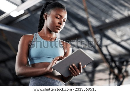 Black woman, planning or personal trainer with a tablet for fitness training, workout or sports exercise. Progress results, digital technology app or gym instructor typing an online coaching schedule Royalty-Free Stock Photo #2313569515