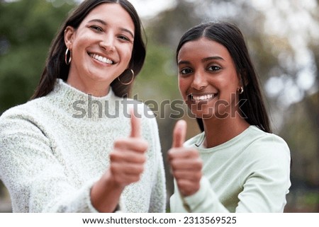 Young women, thumbs up and university students happy for education or success or like their school study as winning friends. Agreement, yes and and female scholars smile for achievement or on campus