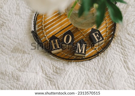 Cozy home. Still life in the living room with wooden inscription home. Sweet home. Home concept.