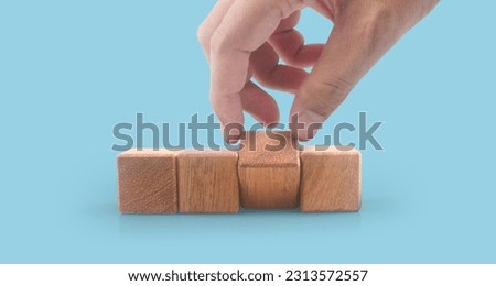 Wooden cubes in a hand with copy space for input wording and infographic