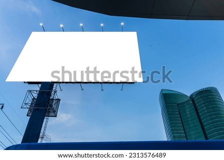 Mock up. A large blank billboard on a street wall signboard with room to add your own message. Empty white billboard on building. Modern ad and commercial concept. clipping path