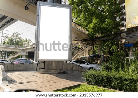 Mock up of light box in a city near traffic jam. Blank banner at dusk for advertising. Blank place for your advertising. Advertising mock up empty banner in metropolitan city, clipping path.