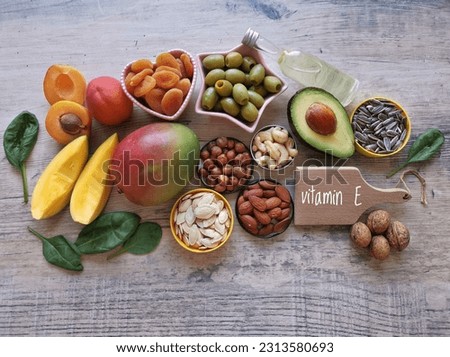 Food rich in vitamin E (tocopherol). Natural products containing vitamins, dietary fiber and minerals. Healthy sources of vitamin E, healthy diet food. Avocado, mango, oil, olives, seeds, apricot nuts Royalty-Free Stock Photo #2313580693