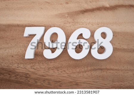 White number 7968 on a brown and light brown wooden background.
