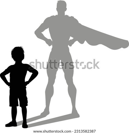 A superhero child or kid boy revealed by his shadow silhouette as a super hero in a cape.