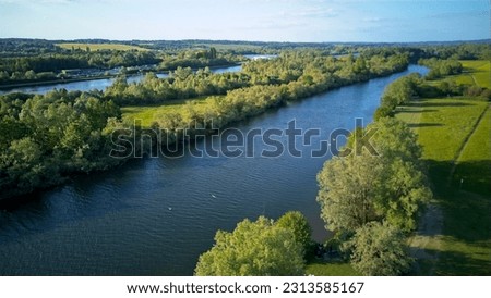 An aerial view along the Thames river by Thames Valley Park heading into Reading, United Kingdom - 03.06.2023