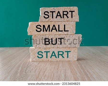 Start small but start symbol. Concept words 'Start small but start' on brick blocks on a beautiful green background. Business, motivational concept. Copy space. Royalty-Free Stock Photo #2313604825