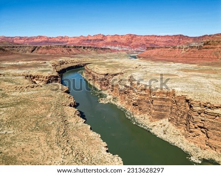 Aerial of The Colorado River Cutting a Green Line through the canyon. Aerial photography. Drone shot. Landmarks of USA. Landscape and wild nature