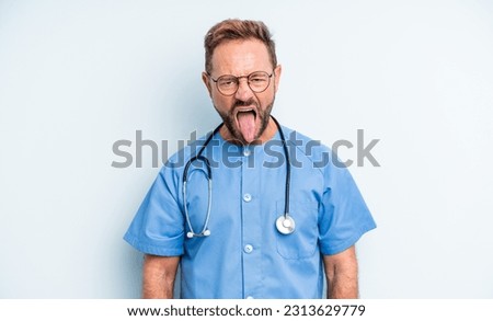 middle age handsome man feeling disgusted and irritated and tongue out. nurse concept