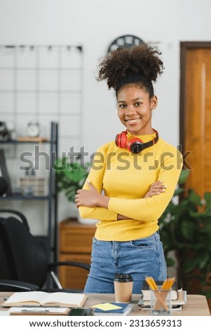 Young African American freelancer working on computer in home office. Female college student.