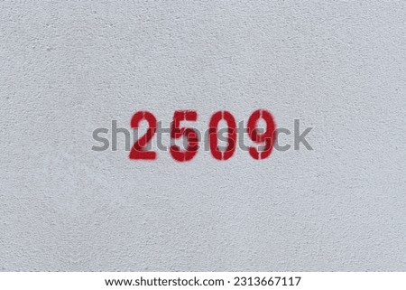 Red Number 2509 on the white wall. Spray paint.
