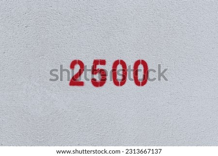 Red Number 2500 on the white wall. Spray paint.

