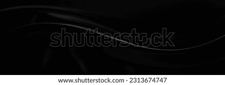 Black gray satin dark fabric texture luxurious shiny that is abstract silk cloth panorama background with patterns soft waves blur beautiful. Royalty-Free Stock Photo #2313674747