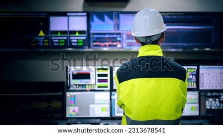 Engineer working at control room,Manager control system,Technician man monitoring program from a lot of monitor Royalty-Free Stock Photo #2313678541