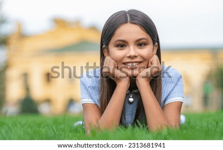 girl relax at summer lawn with grass, copy space. girl relax at summer lawn outdoor.