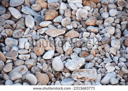 pebble background, Pebbles on Beach Background: Coastal, Serene, Natural Stones for Relaxing Coastal Vibes, Natural Stones
 Royalty-Free Stock Photo #2313683771