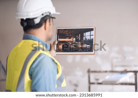 Architect holding picture of project design with modern loft-style interior man in hardhat and vest inspecting premise and imagining living room after renovation