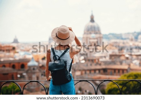Young attractive smiling girl tourist exploring new city at summer Royalty-Free Stock Photo #2313690073