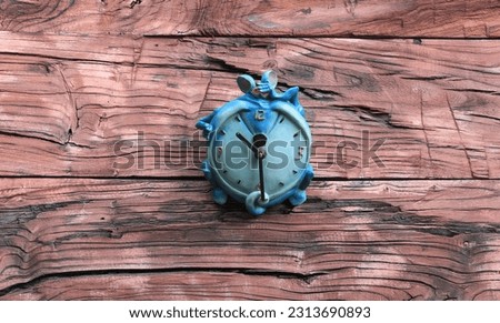 blue kids alarm clock on wooden background