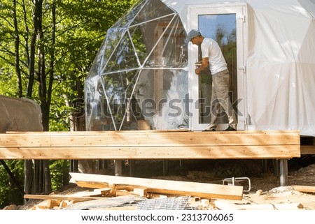 installation of domed on the ground, consisting of steel profiles and plastic Royalty-Free Stock Photo #2313706065