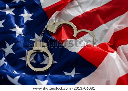 Police handcuffs on the USA flag, close-up