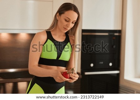 Beautiful young woman is preparing vegetable salad in the kitchen. Healthy Food. Vegan Salad. Diet. Dieting Concept. Healthy Lifestyle. Cooking At Home. Prepare Food. Cutting ingredients on table.