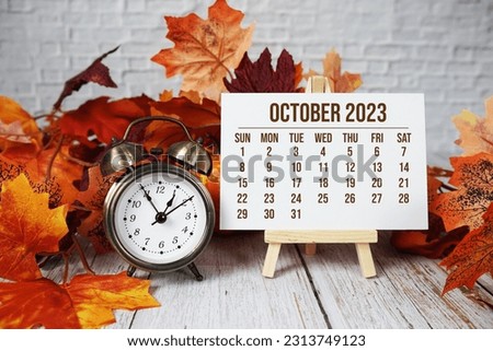 October 2023 monthly calendar maple leaf decoration on wooden background Royalty-Free Stock Photo #2313749123