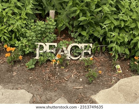 Peace decorative sign in a church front garden on Elgin Street in downtown Ottawa Ontario Canada.