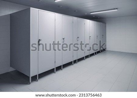 Closed cubicle doors in a public restroom. Public toilet cubicles. Clean toilet, view from inside the room Royalty-Free Stock Photo #2313756463
