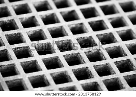 Close up photo of the top cover of a water well. This photo is in black and white.