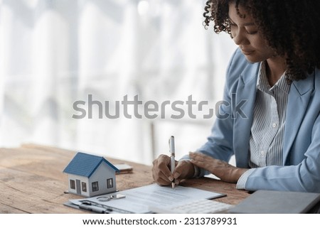 Real estate agent, American businesswoman Africans scrutinize contracts to offer mortgages to clients to make decisions about insuring their homes and land. home mortgage concept, finance, insurance