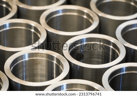 Shiny steel parts background. Regular industrial metal production pattern with selective focus.High precision steel automotive parts manufacturing by innovative CNC machining
 Royalty-Free Stock Photo #2313796741