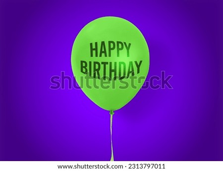 Green balloon with words HAPPY BIRTHDAY on purple background