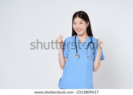 Smiling woman doctor showing mini heart sign isolated on white background.