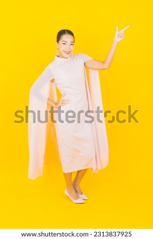 Portrait beautiful young asian woman smile with many action on yellow background