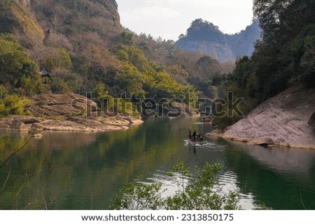 The Wuyi Mountains or Wuyishan are a mountain range located in the prefecture of Nanping, China. Picture of the river and mountains at sunset