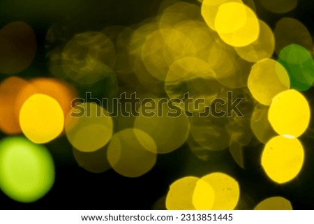 Bokeh abstraction, round bright multi-colored lights out of focus, holiday background.