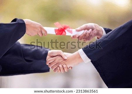 Giving, diploma and people handshake in graduation success, congratulations or thank you. University students, graduate or person shaking hands for certificate, award and scholarship event in closeup Royalty-Free Stock Photo #2313863561
