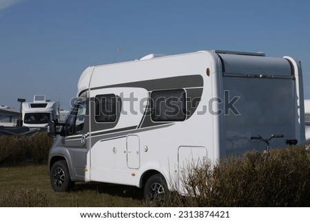  White camper van parking on a camping site.